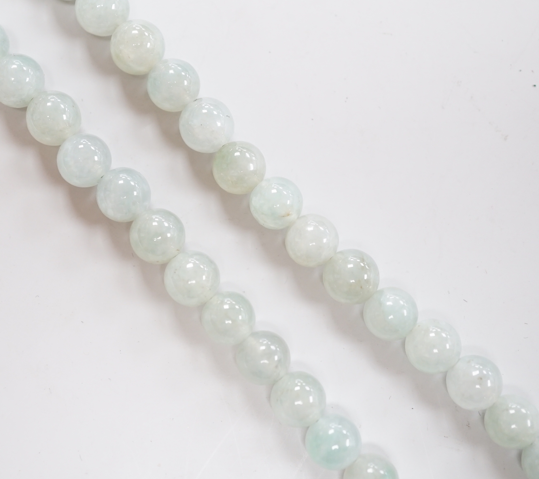 A single strand jadeite bead necklace, with 18k clasp, 43cm, gross weight 58.7 grams, with accompanying Gem & Pearl Laboratory report dated 18/03/2019, stating the jade to have no evidence of treatment.